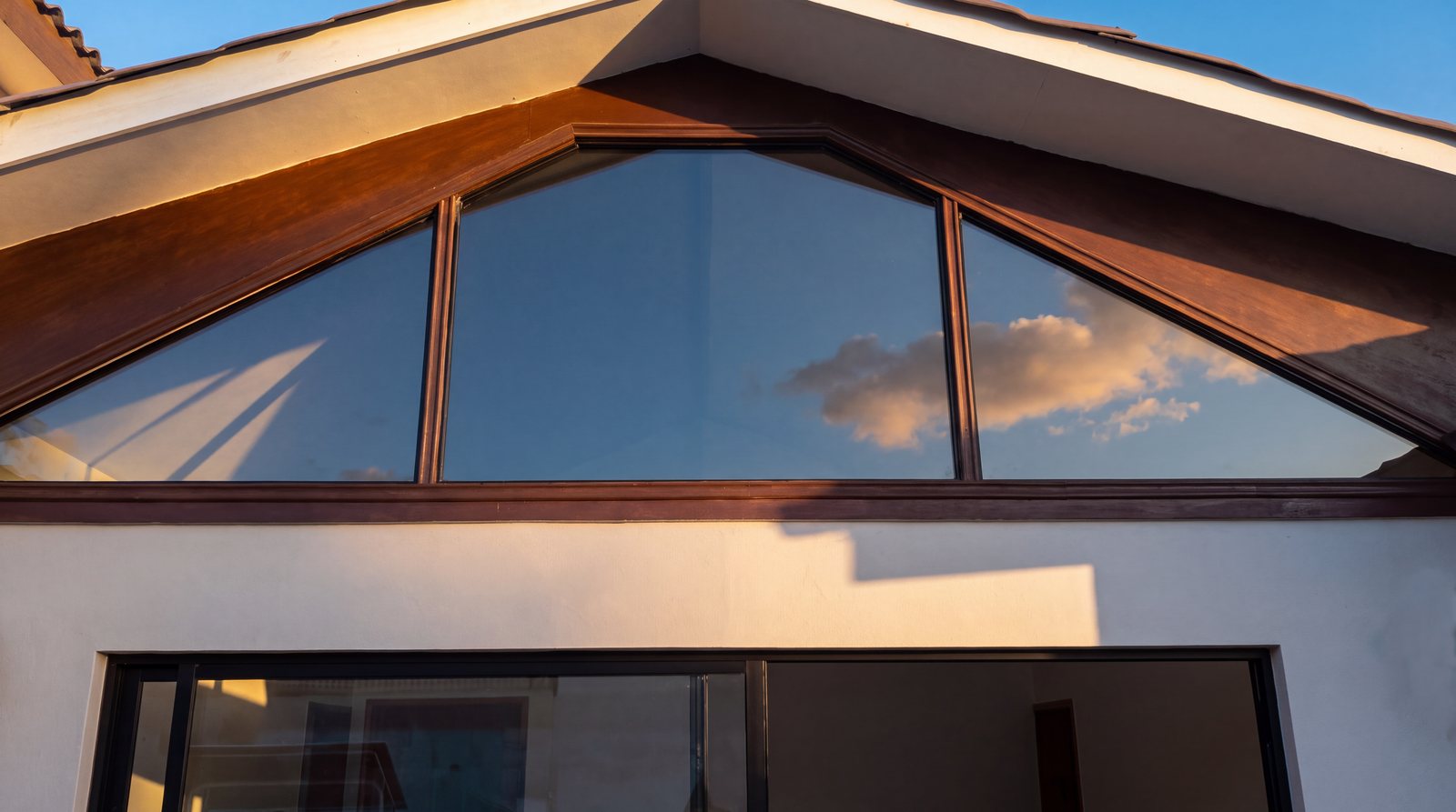 Ventana triangular a medida en el frontón de una casa, obra de INGEALUM